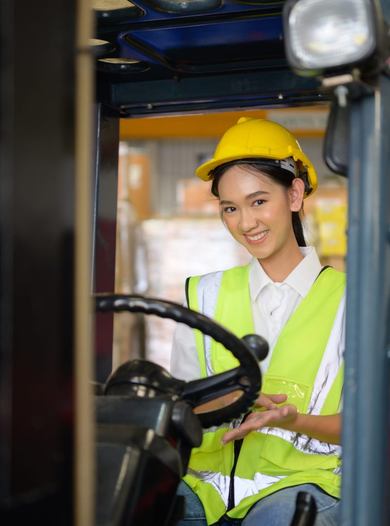 female-worker-driving-forklift-moving-goods-warehouse-practicing-forklift-operation